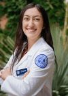 Student in white coat posing for headshot