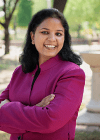 Professor posing in garden for headshot