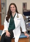 Dr. Boburka profile picture in white lab coat in a physician assistant setting with equipment.