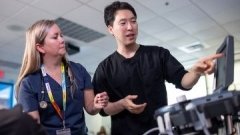 student and teacher viewing a lab monitor