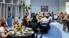 event with people eating at many round tables