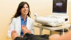 Podiatrist examines patient's feet.