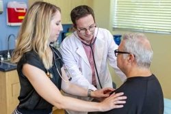 patient being examined with stethoscope