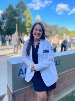 Robin Moscovitch poses in White Coat