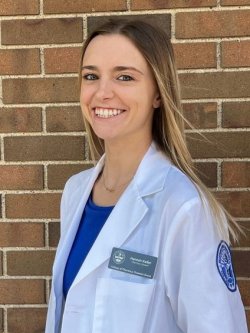 Hannah Keller stand by brick wall