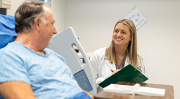 Midwestern University student consulting with patient in hospital.