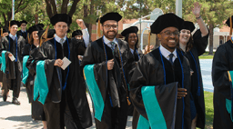 Smiling students graduating from the Arizona College of Optometry.