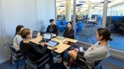 Speech language students studying in the Midwestern library.