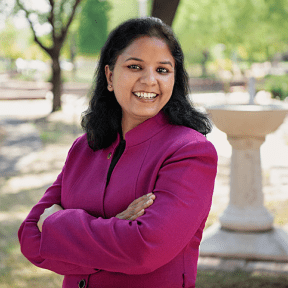 Professor posing in garden for headshot