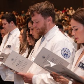 White coat ceremony with students reciting an oath