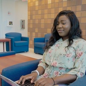 Miriama Bah works on her laptop.