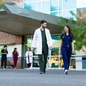 clinicians walking outside medical building