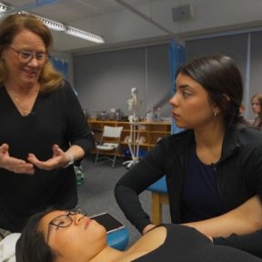 Physical therapy student, Iliana Alvarez, works in the lab with a faculty member.
