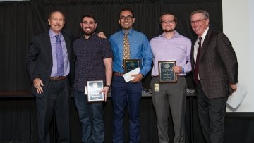 Students holding their awards.