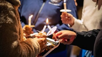 Students lighting candles during the Mahsa Amini Memorial Vigil.