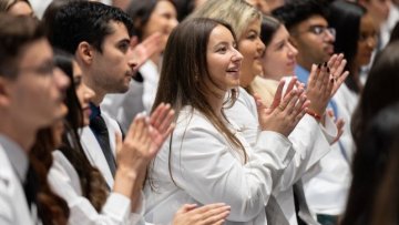 students clapping in the audience