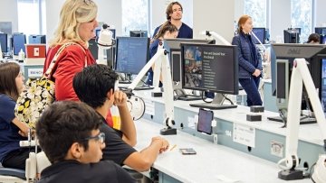 High school students viewing a presentation in the dental medicine lab.