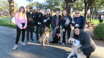 Midwestern community runs with their dogs in the Pup Strut race.