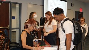 Author Riva Lehrer signs autographs.