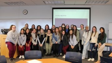 SLP DEI group gathers for a classroom photo.