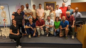 Group picture of international visiting osteopaths with Dr. Heinking and the OMM student scholars. 