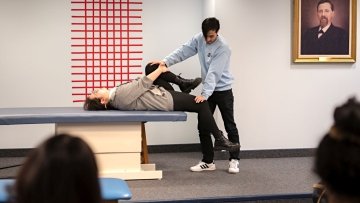 Medical students demonstrate an osteopathic manipulative medicine technique.