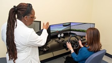 Dr. Wright explains the simulation program to one of the participants.