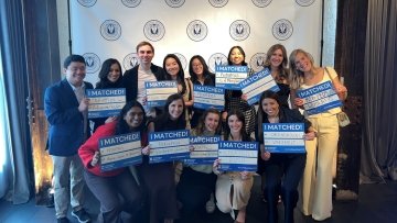 CCOM students hold up Match Day signs