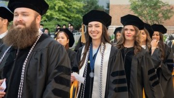 students process into the auditorium 