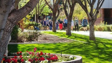 large group walking outside on campus