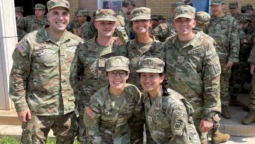 MWU student pose for photo while in military gear