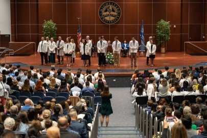 Students receive their white coats.