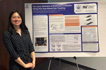 Erin Zou stands in front of research poster