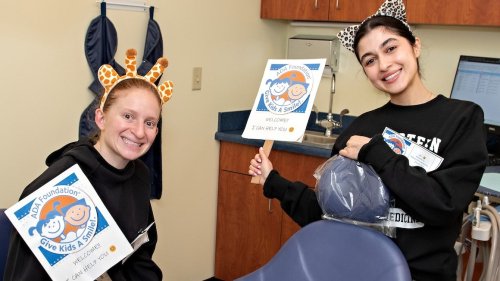 dental students with Give Kids a Smile banners