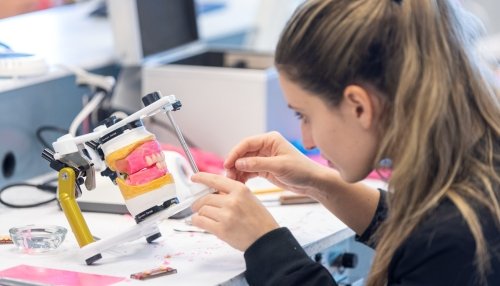 A student works in the Dental Sim Lab at Midwestern University.