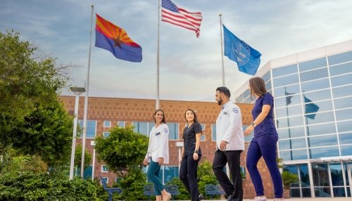 Students walking by flags