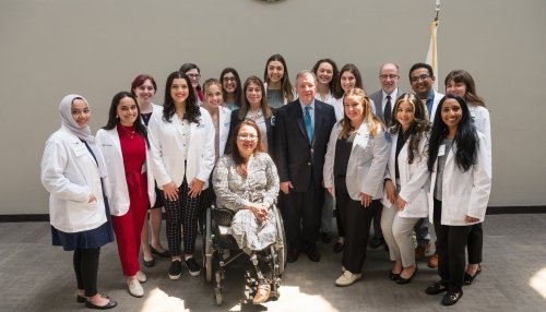 White Coat Students standing in Midwestern Hallway.