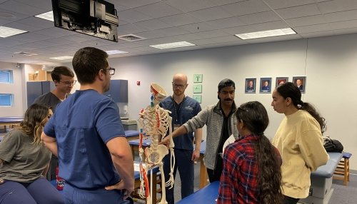 High School Students looking at a skeleton