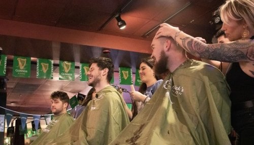 Students and faculty getting heads shaved.