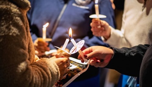 Students lighting candles during the Mahsa Amini Memorial Vigil.