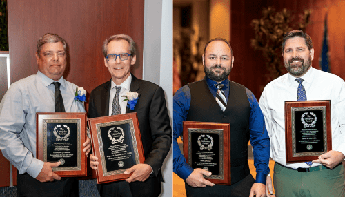 Recipients of the Littlejohn Award display their plaques. 