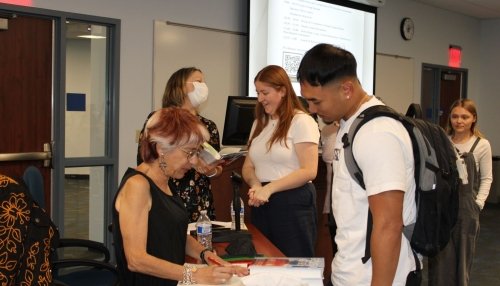 Author Riva Lehrer signs autographs.