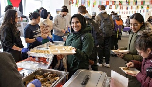 Students stand in line for cultural dishes.