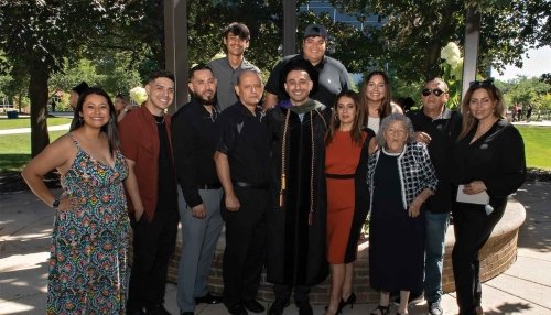 Graduate poses with his extended family at the Downers Grove campus