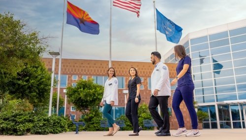 Students walking by flags