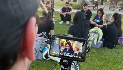 A cameraman for The College Tour takes video of Midwestern University students.