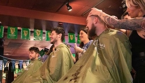 Students and faculty getting heads shaved.