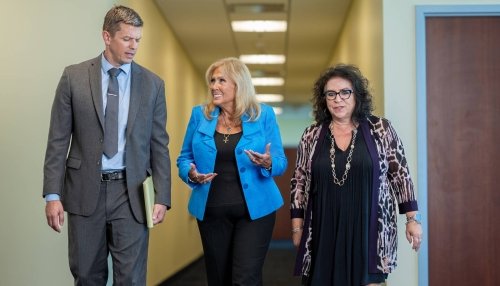 Nursing faculty walking down a hallway on the Glendale campus.