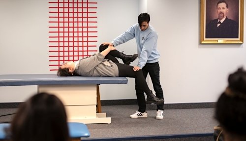 Medical students demonstrate an osteopathic manipulative medicine technique.