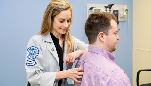 Dr. McKinnon performs an exam on a patient.